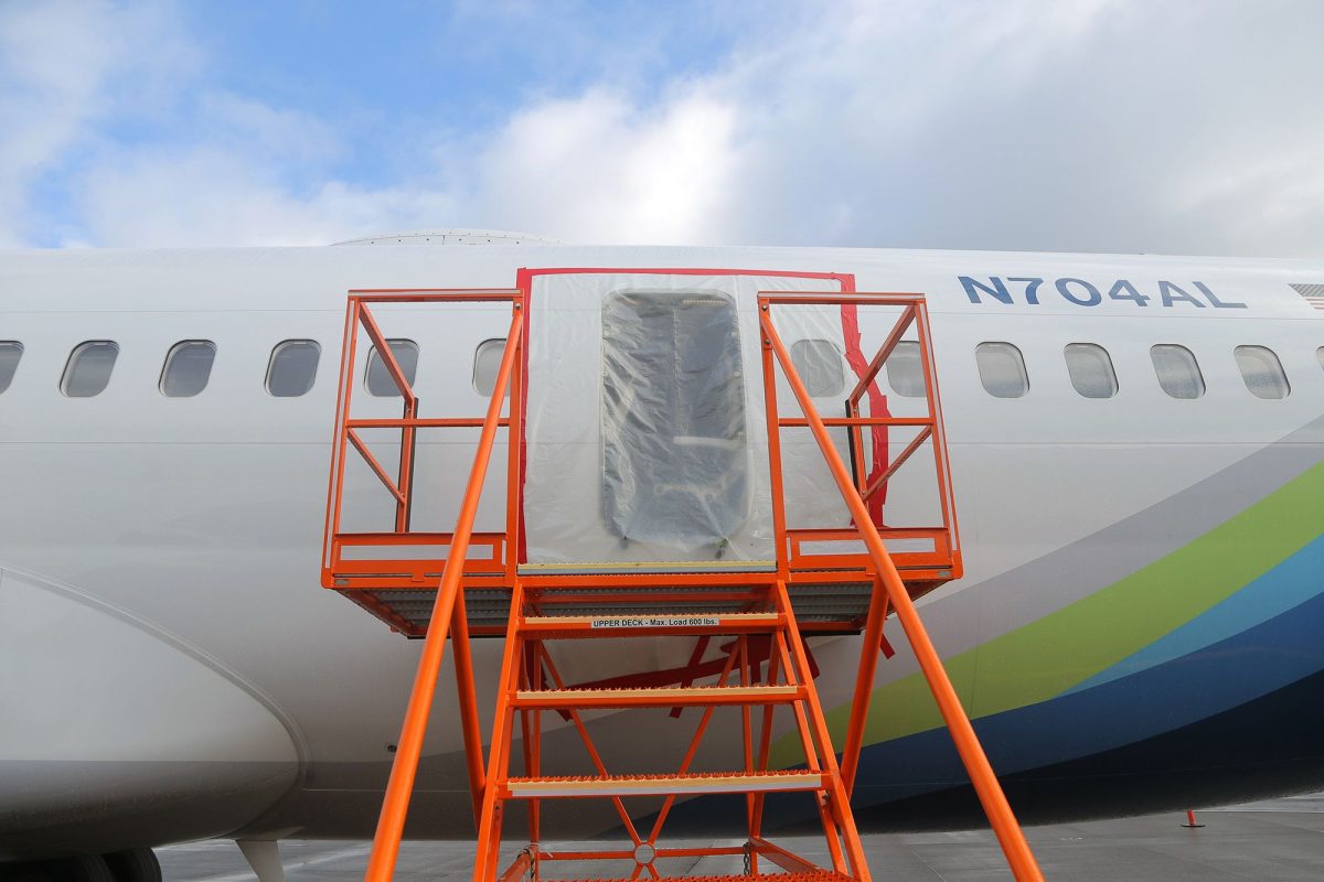 Plastic covers the exterior of the fuselage plug area of Alaska Airlines Flight 1282 Boeing 737-9 MAX in January 2024 in Portland, Oregon.