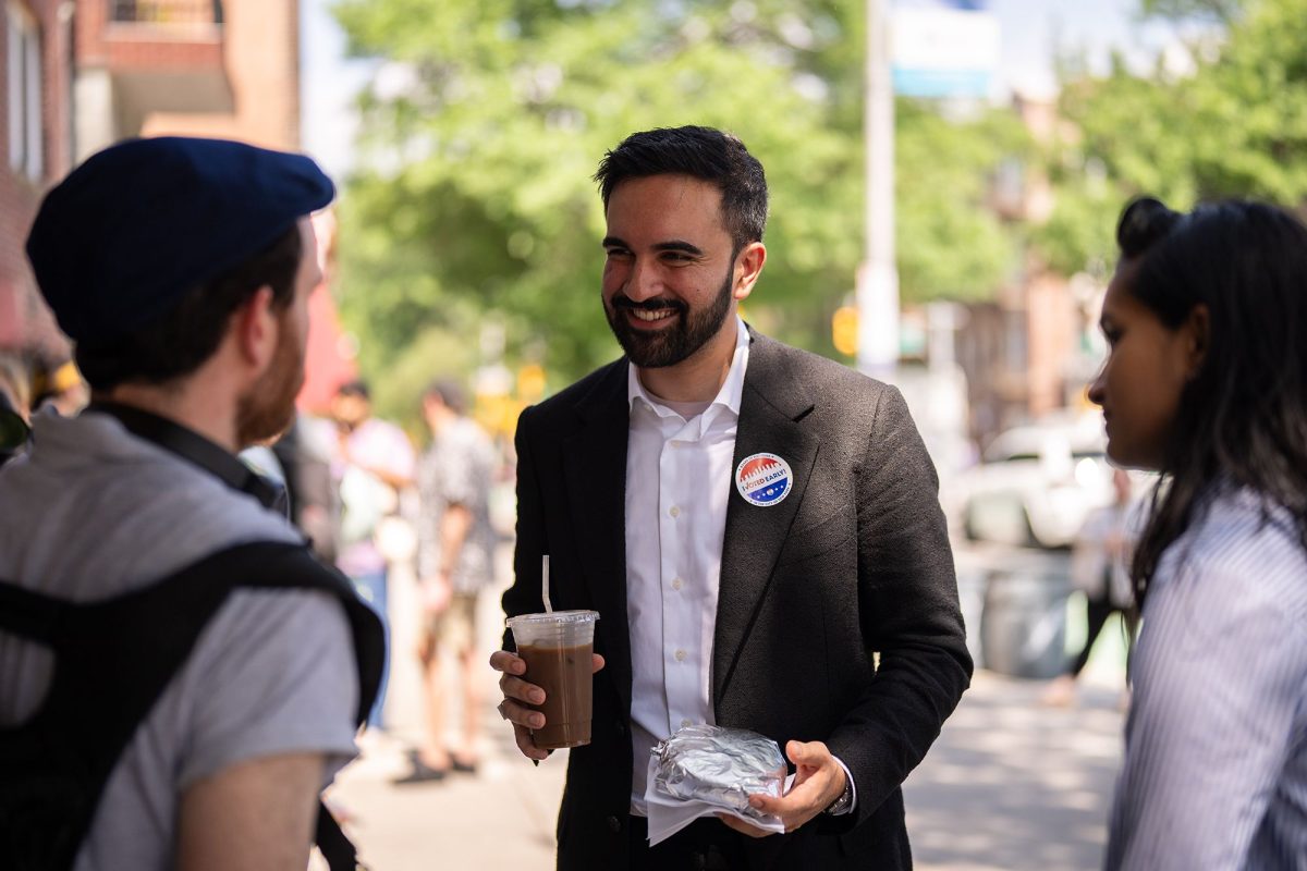 Zohran Mamdani, New York City mayoral candidate, speaks to pedestrians after a campaign event.