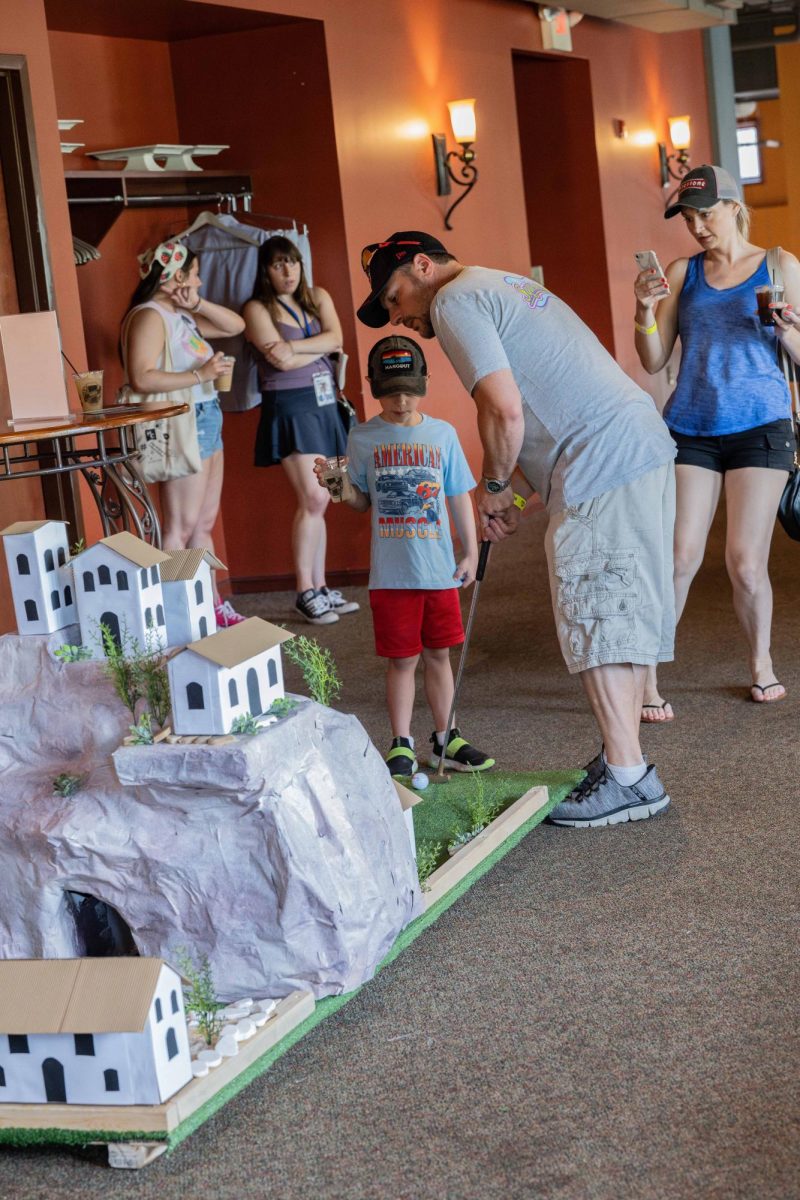 Dan Panama and his wife Diana Panama, and their son Anthony Panama attend Putt Around Town for the first time. 