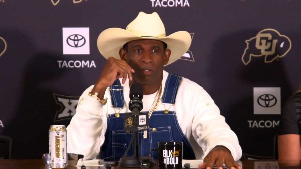 	Colorado head coach Deion Sanders talks to reporters on July 28. Sanders said he has fought – and beaten – cancer after having his bladder removed, shedding light on the latest health struggles that have plagued the hall of famer.