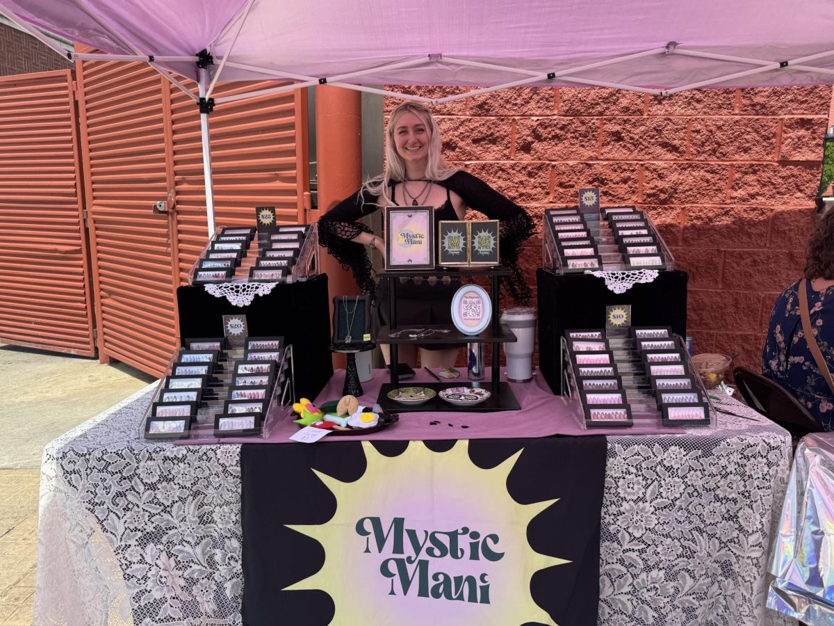Nicole Joseph, owner of Mystic Mani and Acorn Alley social media and event coordinator, with her booth at the Whimsical Witches Market. 
