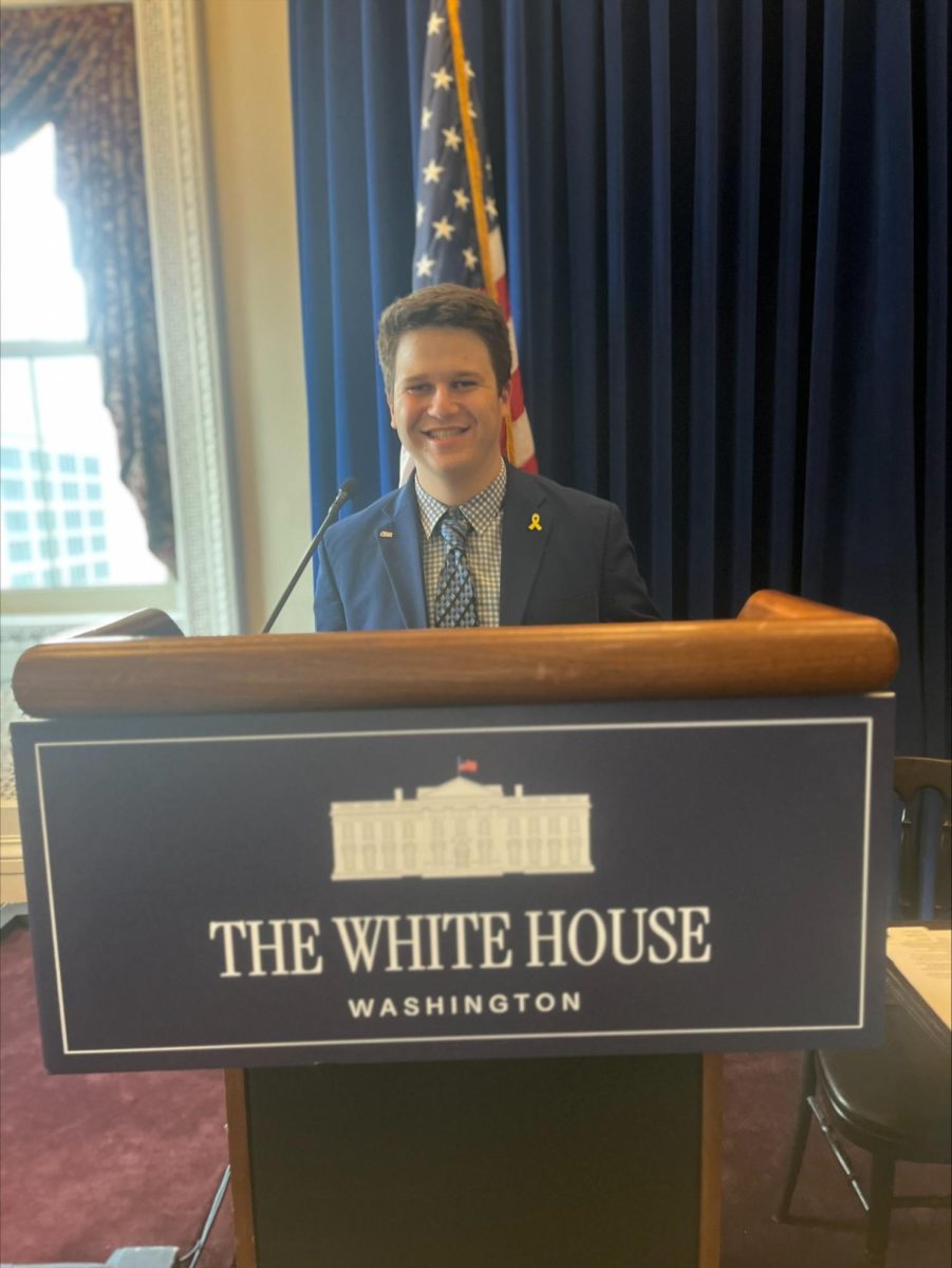Parker Heller, junior business management major and president of Students Supporting Israel, poses for a phot in front of a White House podium.