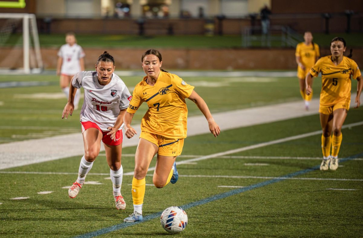 Kent junior Kiyomi McCausland dripples away from YSU senior Chloe Weiland during the second half of the game on Thursday, Aug. 28, 2025.
