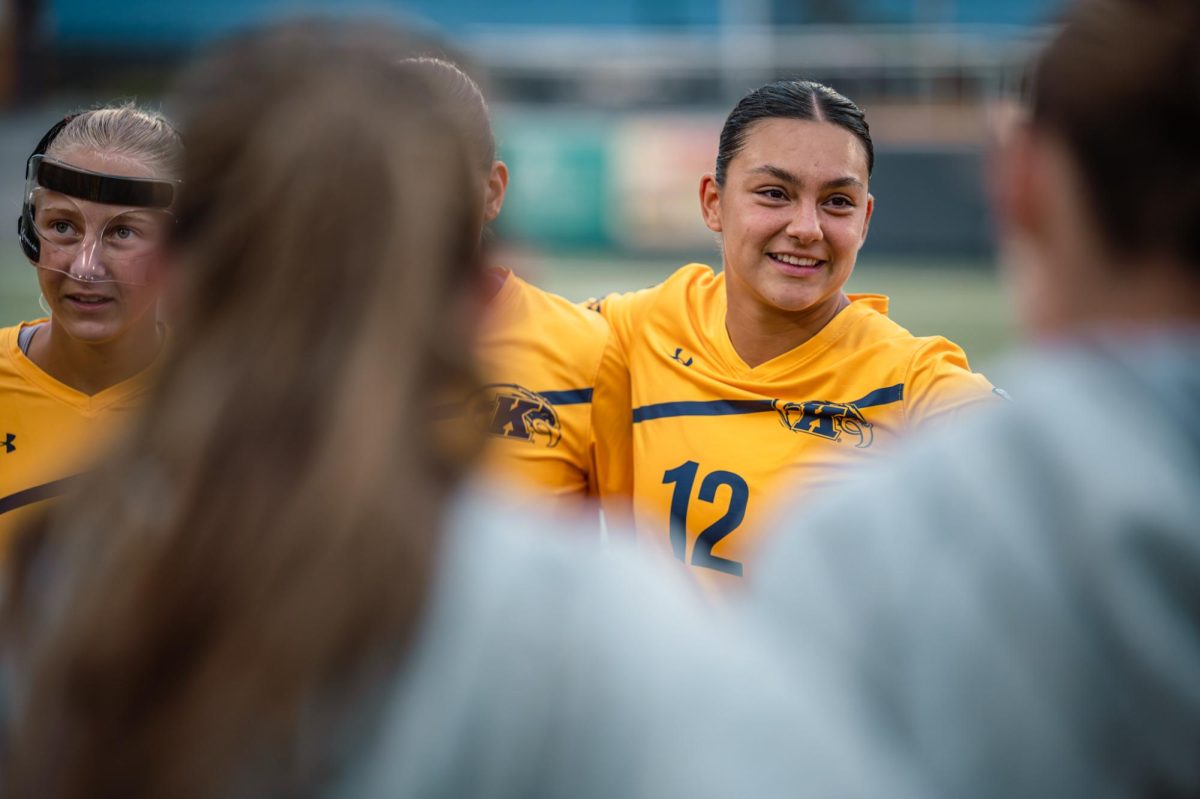 Kent sophomore, Jules Dolinski, smiles in the huddle with her team before their game against YSU on Duquesne on Aug 17, 2025. 