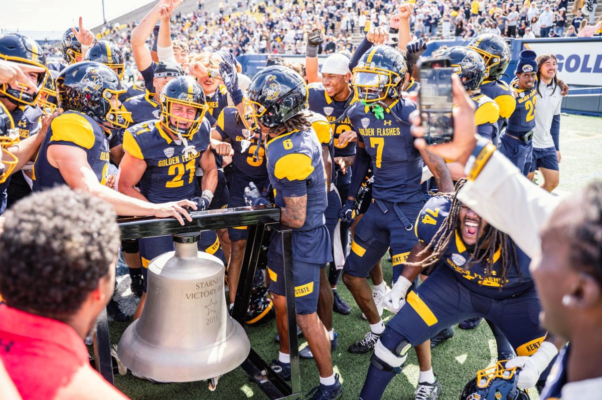 Kent State Football team rings the victory bell after their first win of the season against Merrimack on Aug. 30, 2025.