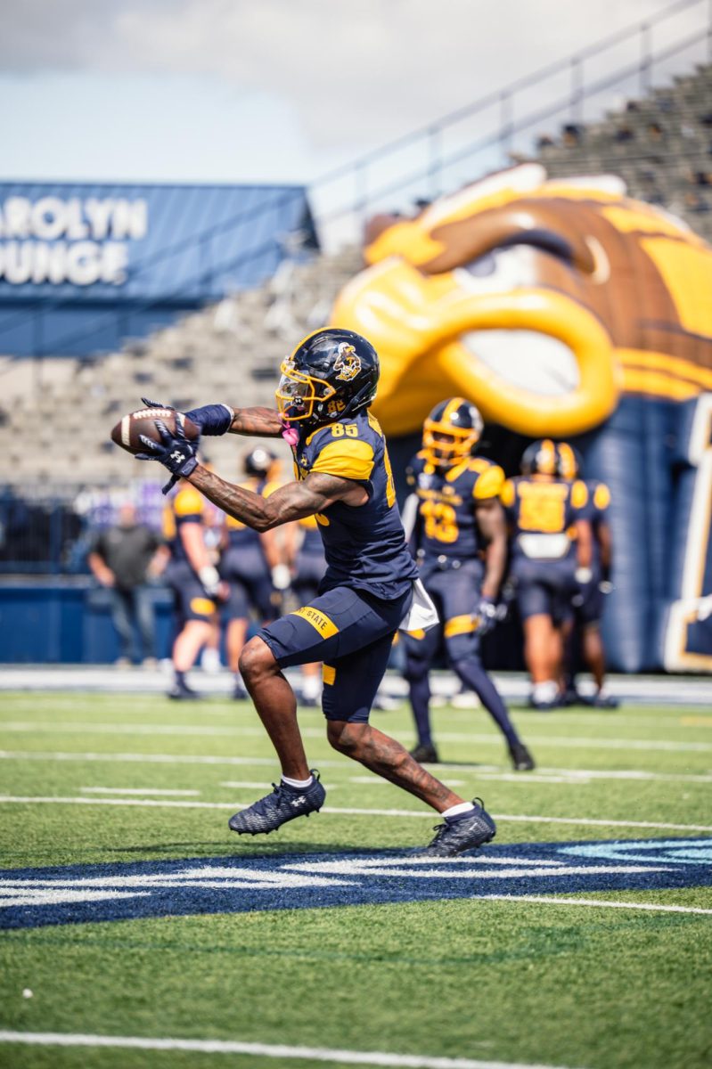 Kent graduate student Sebastian Brown catches the football during warm ups before the game against Merrimack on Aug. 30, 2025.