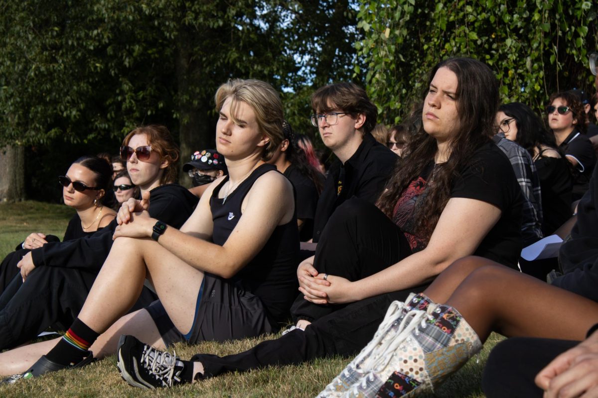 Kent Students sit on the grass outside of the house where the Women's Center was to listen to speeches after the OSA blackout protest on Wednesday, Aug 27, 2025. 