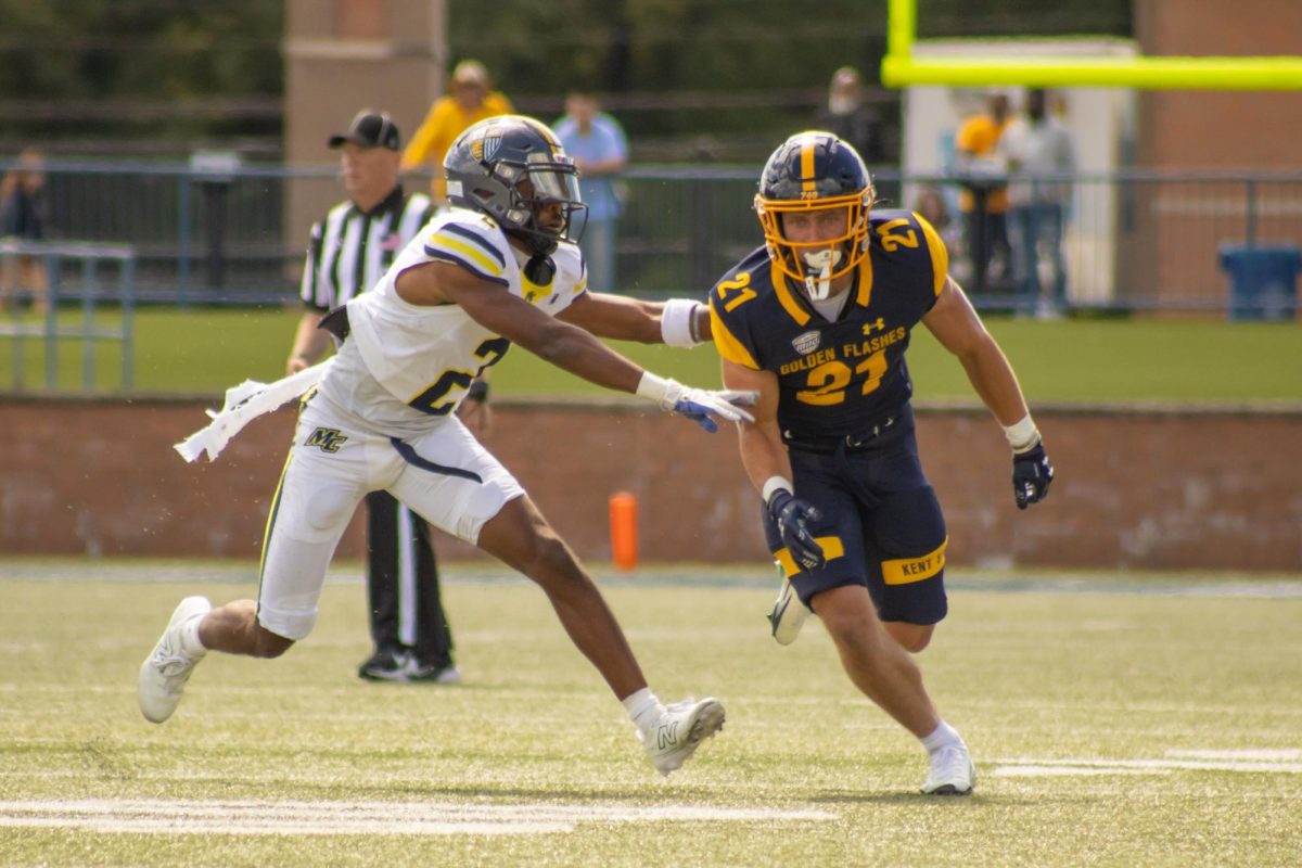 Wide Receiver, Cade Wolford, 21, runs his route as the Merrimack player tries to defend against him in the third quarter of the home opener on Saturday, Aug. 30, 2025.