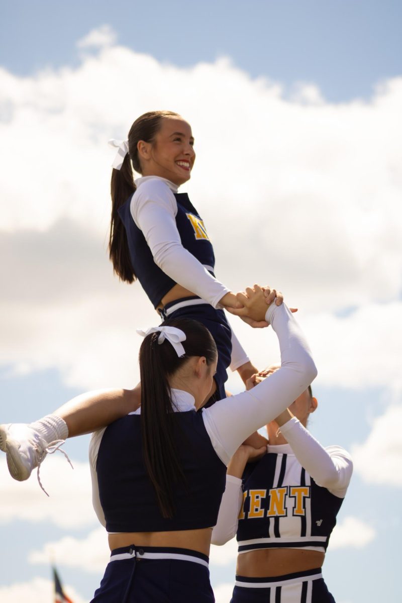 Second year cheerleader Anna Marks being held up by squadmates in the home opener on Saturday, Aug. 30, 2025.