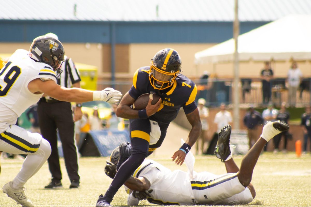 Quarterback, CJ Montes, 7, rushes down the field escaping Merrimacks players in the home opener on Saturday, Aug. 30, 2025.