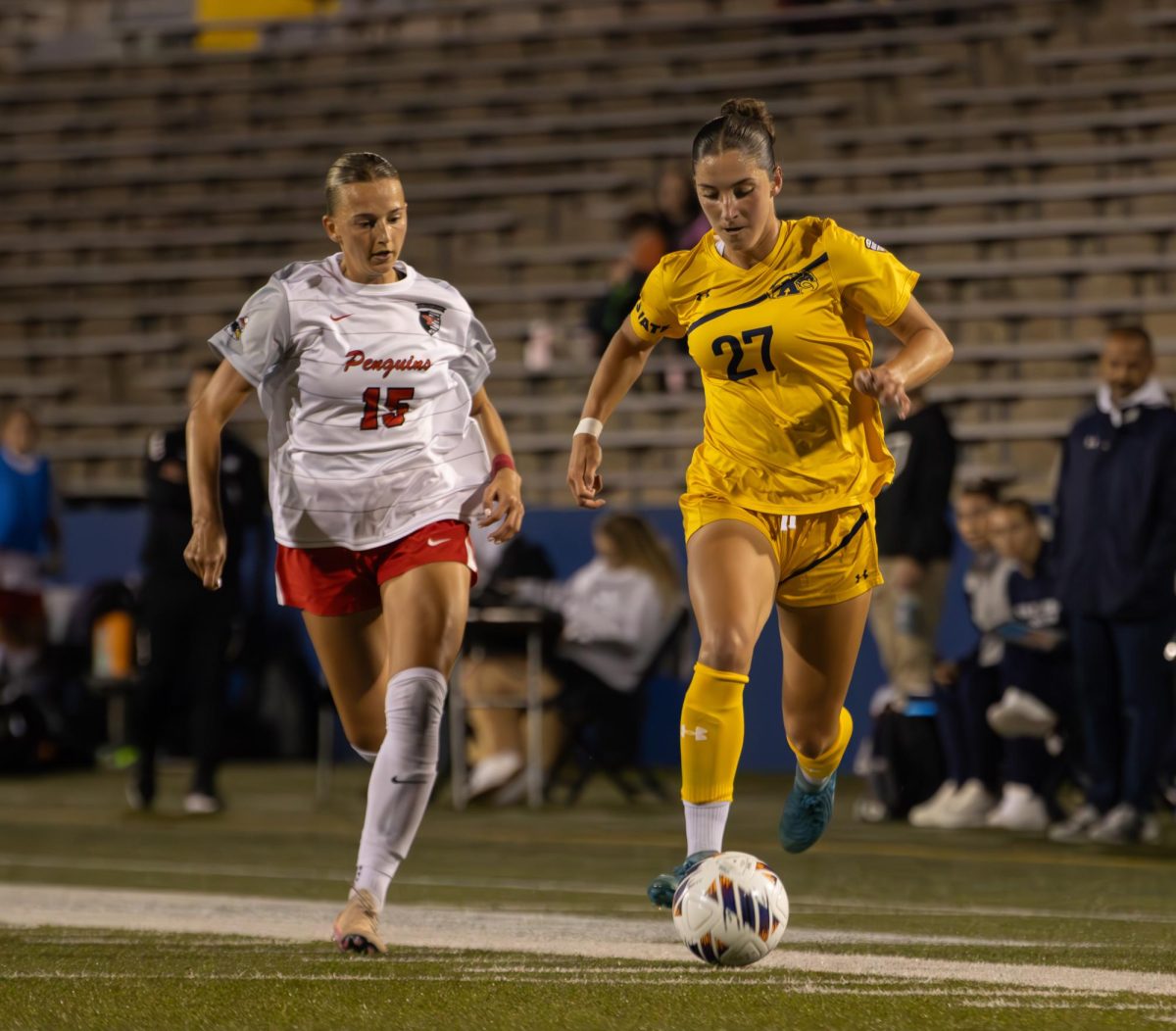 Kent freshman forward, Mia Cleroux, 27, dribbles the ball as Youngstown State senior defender, Emma Rigone, 15 runs next to her during the second half of their match on Thursday, August 28th, 2025. 
