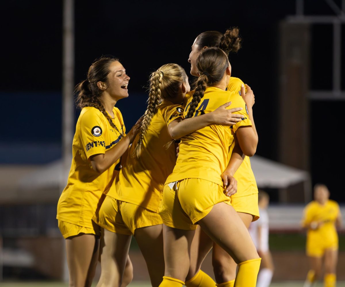 Members of the Kent State women's soccer team hugs Kent freshman forward, Mia Cleroux, 27, after scoring a goal in the second half of their game against Youngstown State on Thursday, August 28th, 2025. The score made it five to 1 in the second half.