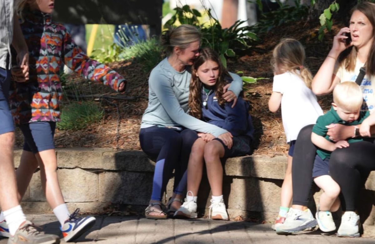 Parents and children await news after the shooting at Annunciation Church in Minneapolis on August 27.