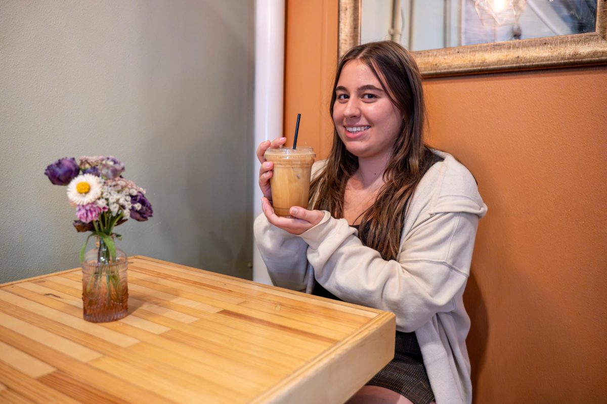 Adriana Gasiewski posing with a pumpkin shaken espresso from Scribbles Coffee Co. on Aug. 25, 2025.