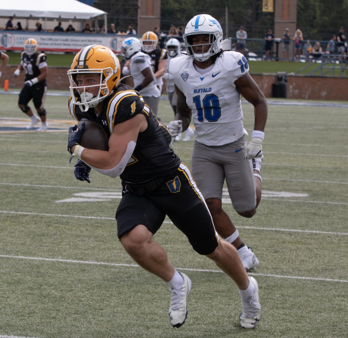 Kent redshirt freshman, Cade Wolford, runs toward the end zone before scoring a touchdown as University of Buffalo player, Jamiere Munson, runs after him during the second quarter of their game on Saturday, Sept 13, 2025. After Kent scored the touchdown, it made the score 14-0.