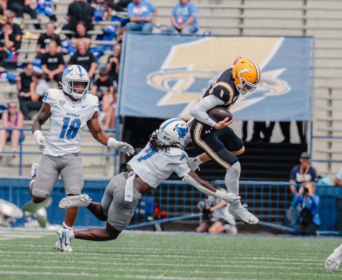 Kent redshirt freshman Dru DeShields jumps to avoid Buffalo sixth year, Solomon Brown, in the first quarter on Sept. 13, 2025. 