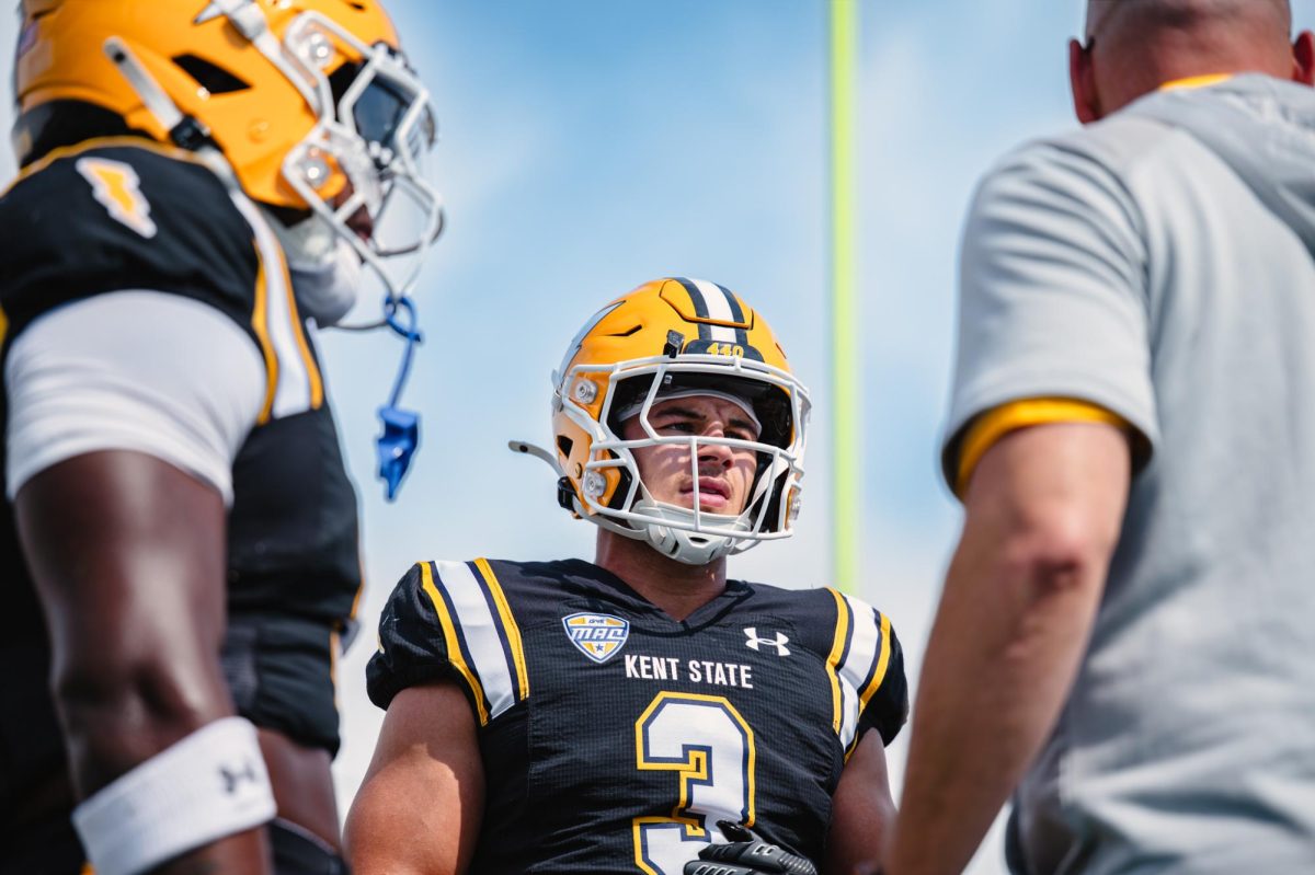 Kent redshirt sophomore CJ Young huddles up with teammates and coach before the game against Buffalo on Sept. 13, 2025.