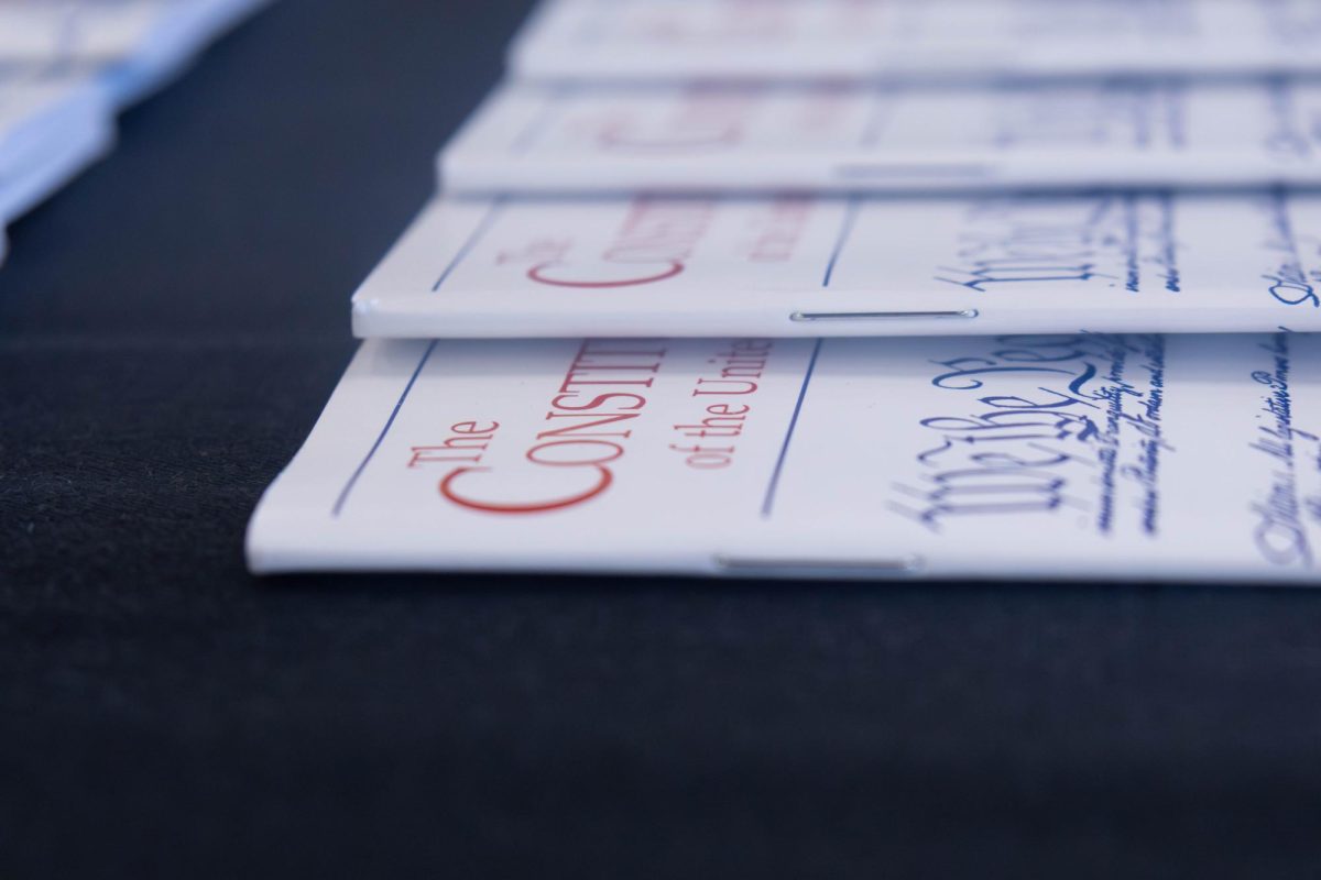 Portable copies of the U.S. Constitution are laid out at the Equal Protection Under the Law Constitution Day event in the library, Sept. 17, 2025.