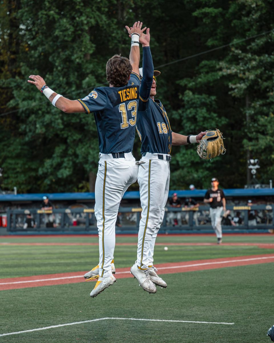 Kent redshirt sophomore Landon Tiesing, 13, and Senior Matt Thompson, 18, celebrate at the end of the third against Ontario on Sept. 18, 2025.