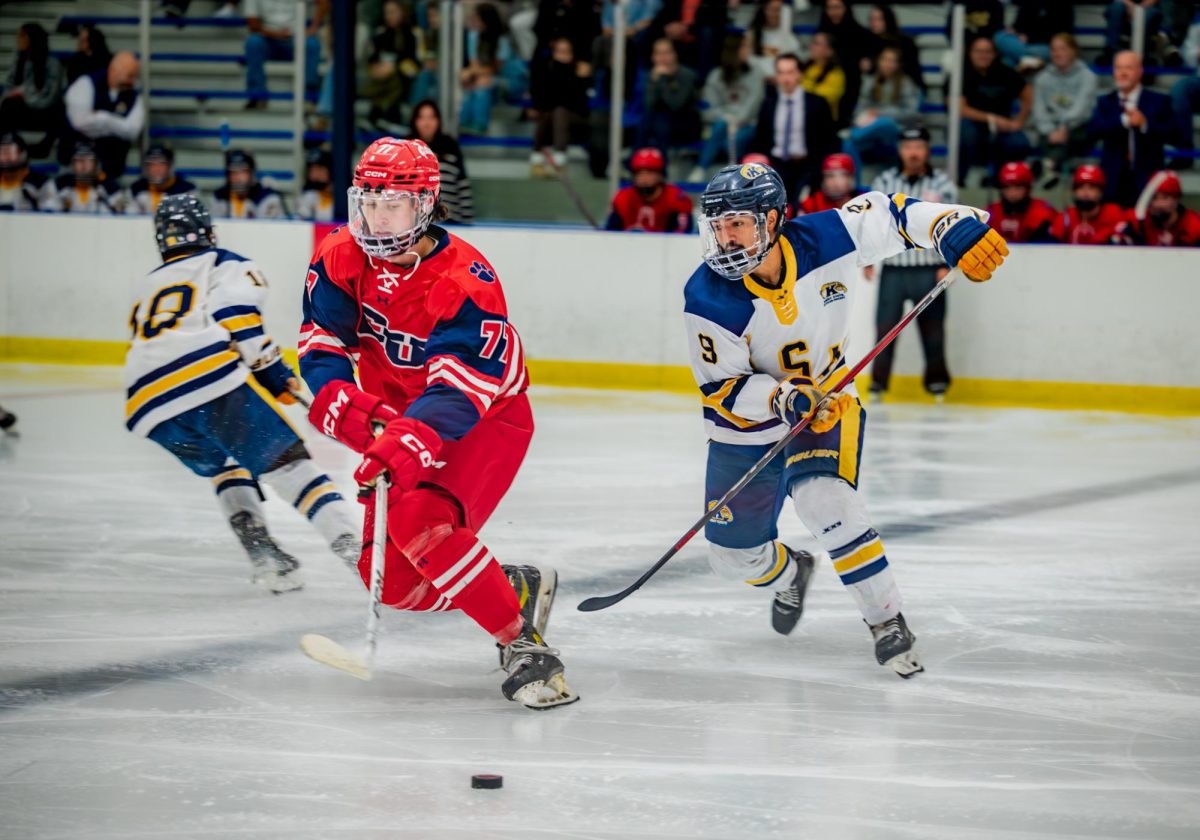 Kent sophomore Adrian Sanchez and Cleary freshman Bailey Ewonus skate towards the puck in the third period on Sept. 26, 2025.