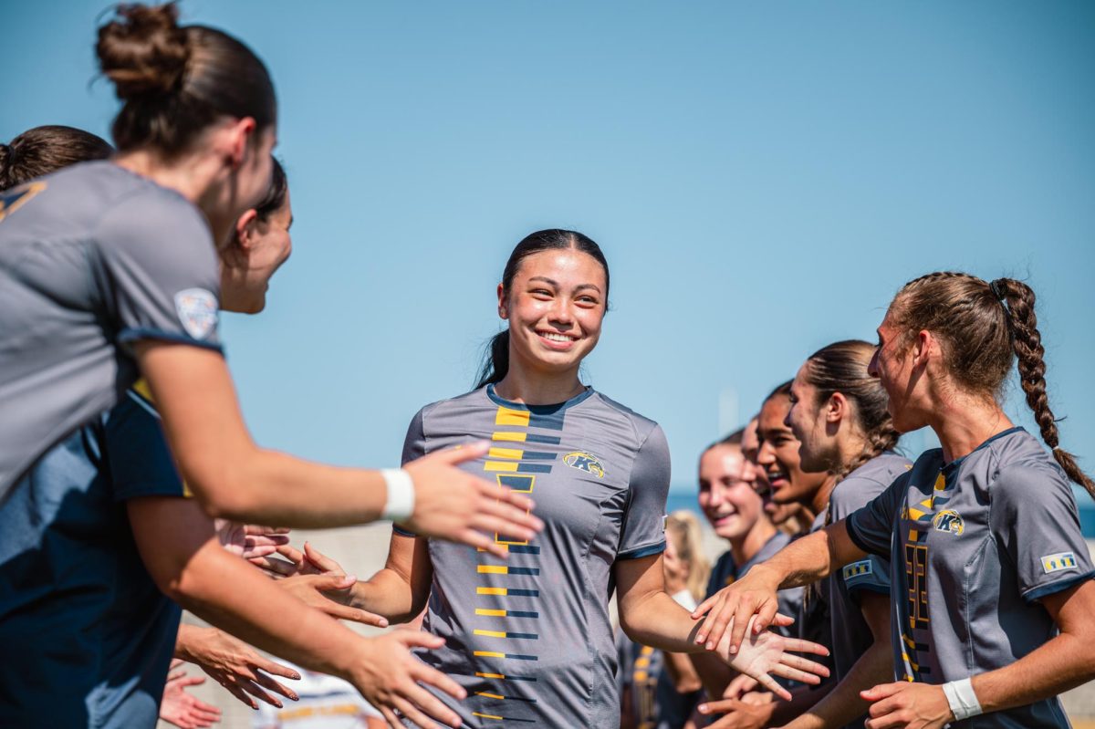 Kent sophomore Katie Henahan runs through her cheering teammates before the game against Buffalo on Sunday, Sept. 28, 2025.