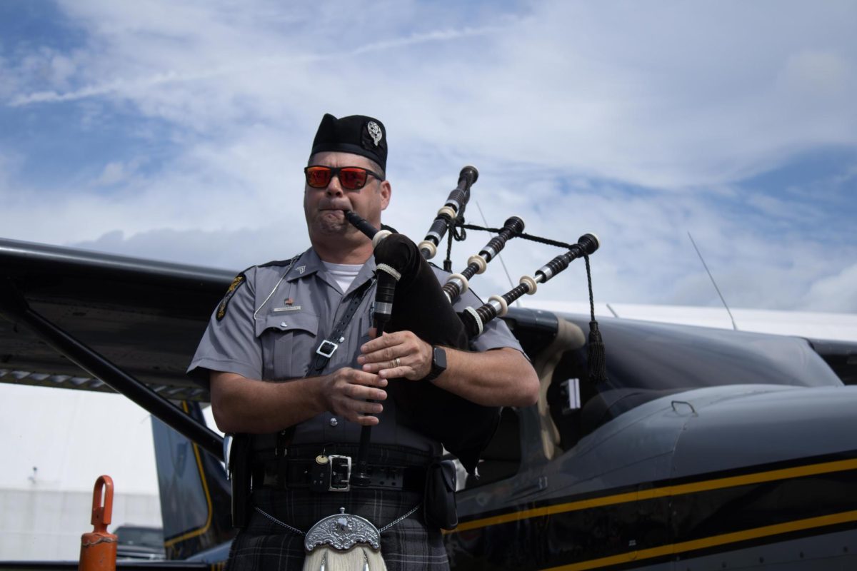 Ohio State Highway Patrol bagpiper, John McGlashan, plays the bagpipes in front of the Ohio State Highway Patrol airplane during the Aeronautics and Engineering Expo on Saturday, Sept. 6, 2025.