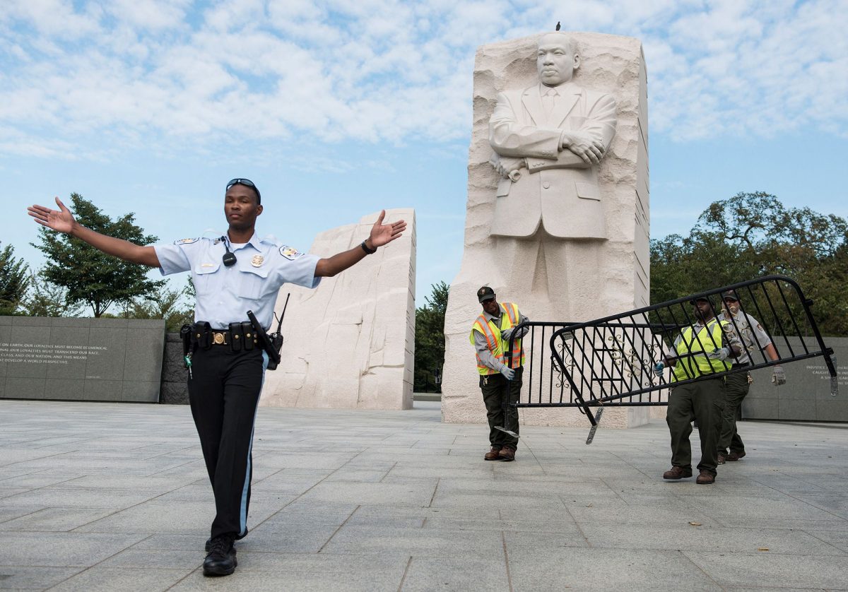	A US Park Police officer and National Park Service employees close the Martin Luther King Jr. Memorial in Washington, DC, during the shutdown in October 2013.