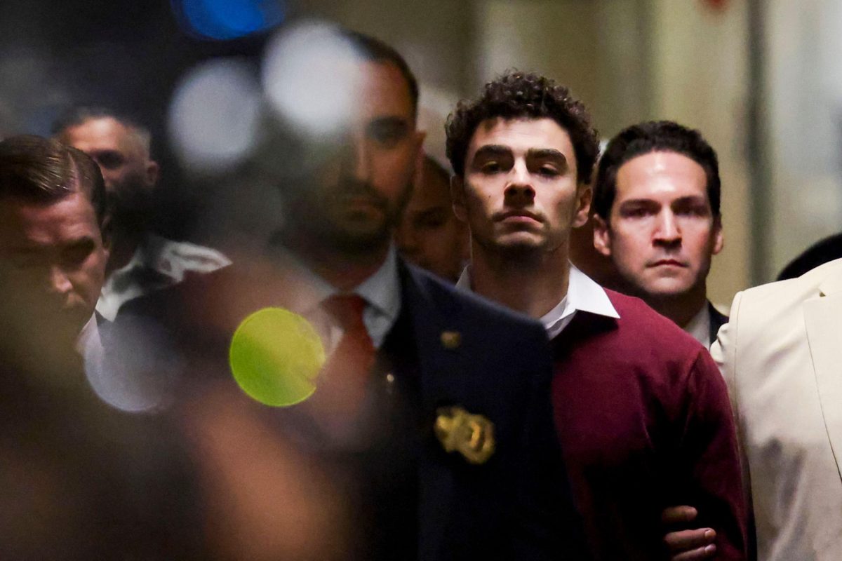 Luigi Mangione, center, arrives at New York State Supreme Court in New York for his arraignment on December 23, 2024.