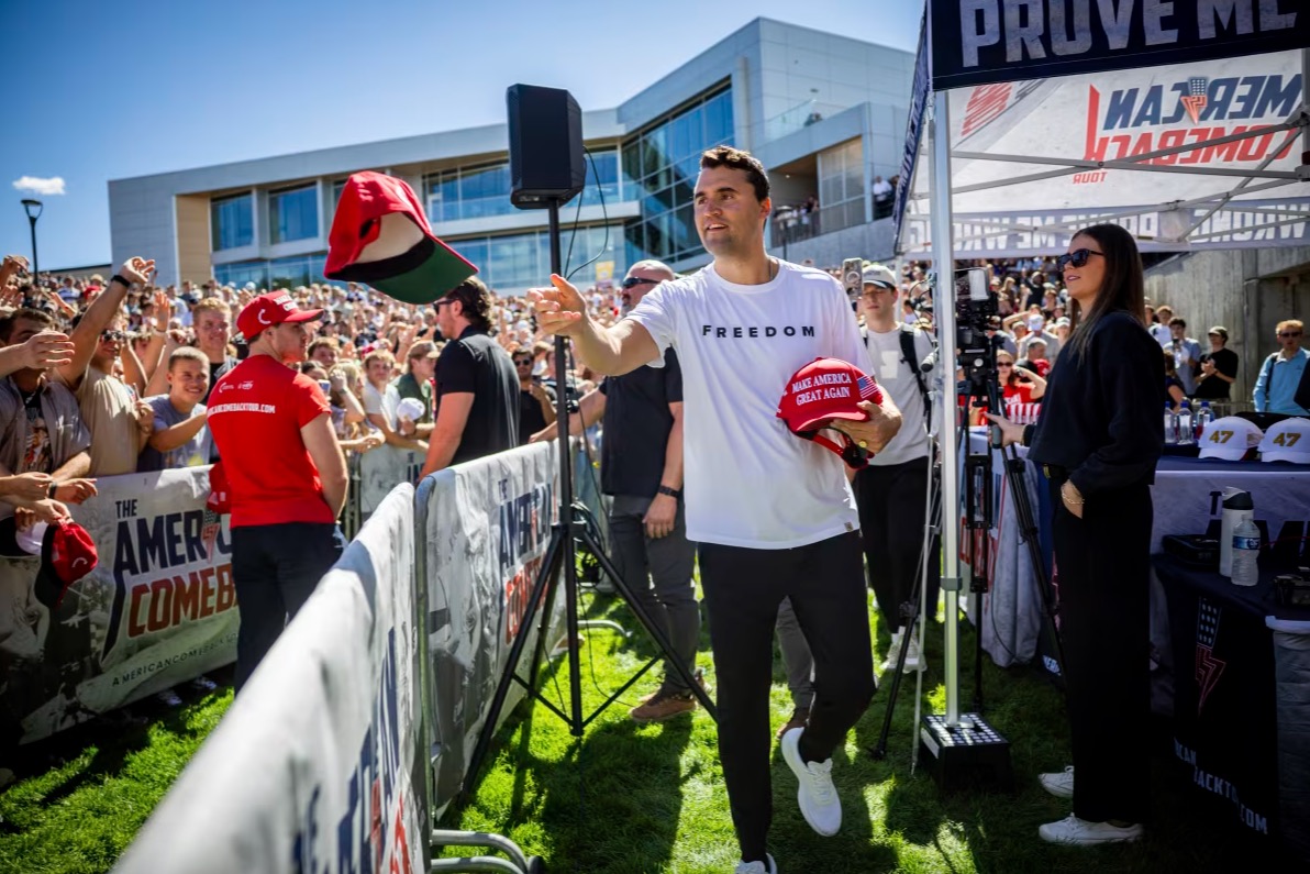 Charlie Kirk hands out hats before speaking at Utah Valley University in Orem, Utah, on September 10.