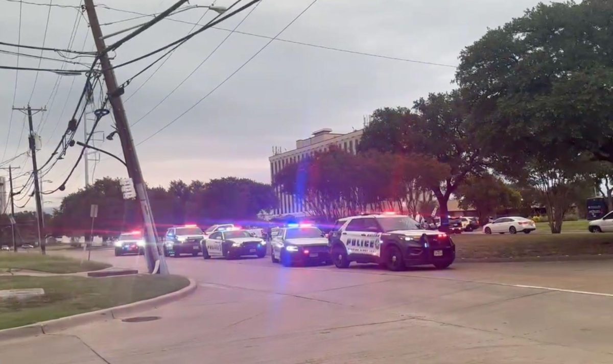 Police are seen near the scene of a shooting at an ICE facility in Dallas on Wednesday.