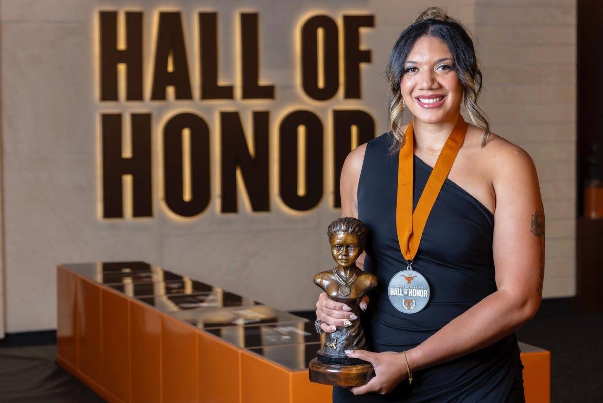 Kent State volleyball coach Haley Eckerman poses with her Texas Hall of Honor trophy.