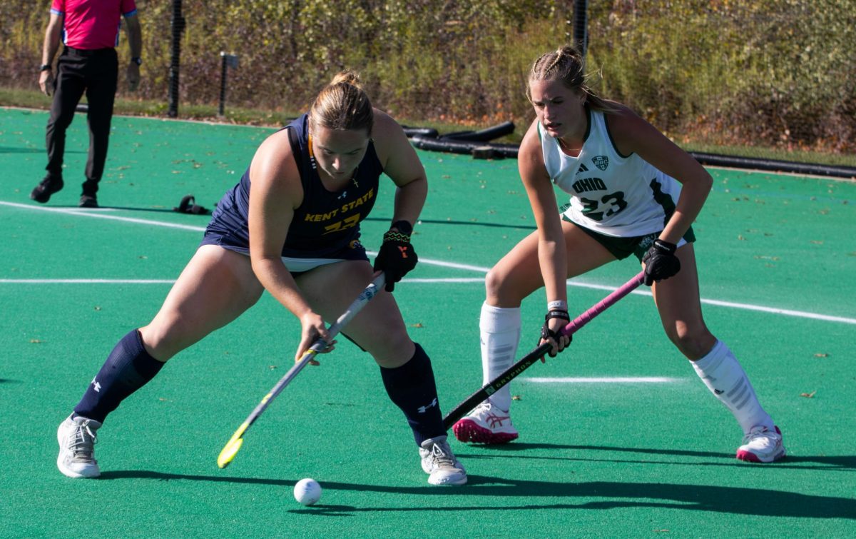 Kent forward freshman, Emily Robertson moves the ball as Ohio University junior midfielder, Emily Beitzel tries defend as she moves around her during the third quarter of their game on Friday, Oct. 17, 2025.