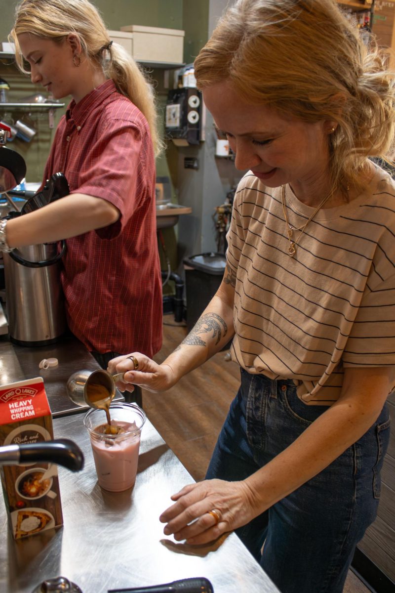Scribbles Coffee Company manager, Beth Budzar, pours coffee into a cup to make the Her Latte on Saturday, Oct. 18, 2025.
