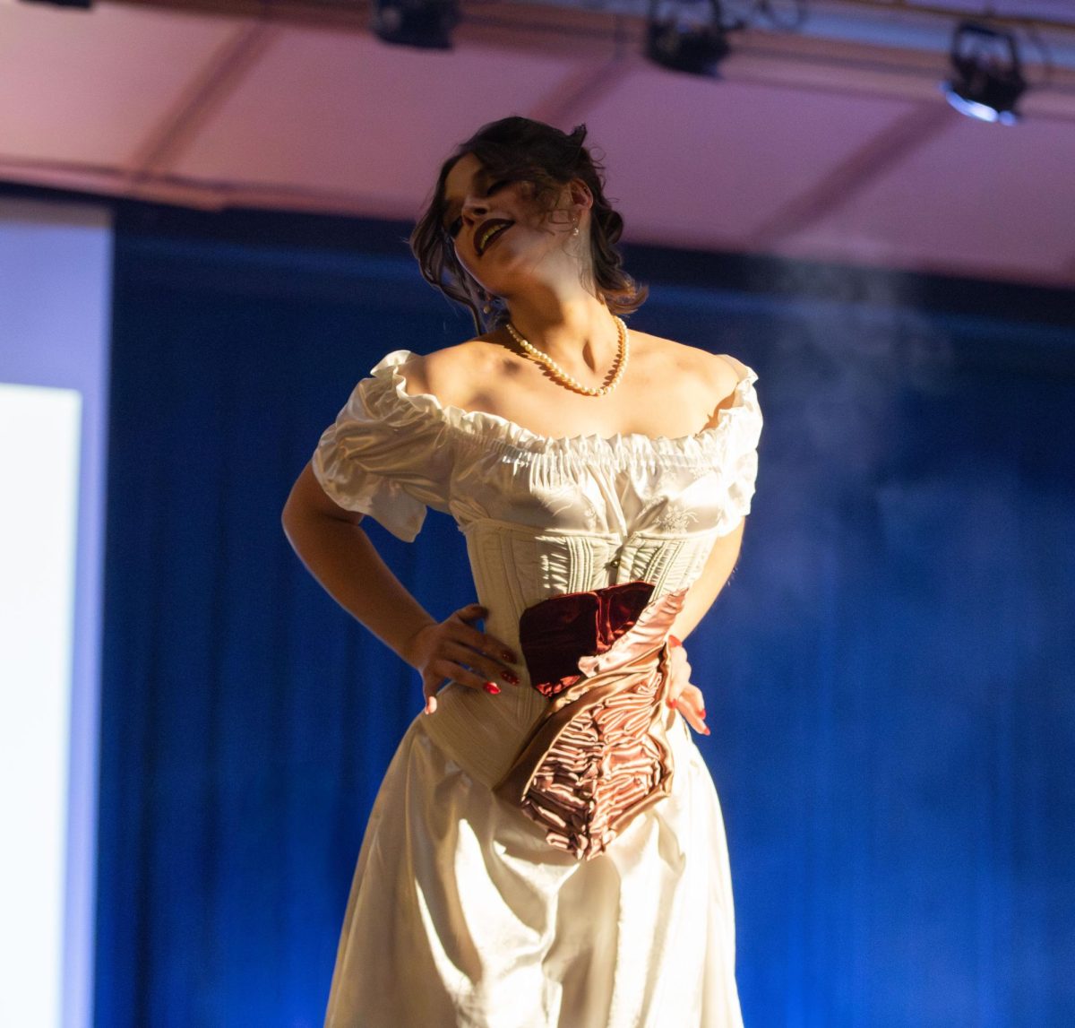 Kent designer Kylie Crown strikes a pose in her own design that she created for the Modista X Phi Delta Epsilon Fashion Show on Saturday, Oct. 18, 2025.

