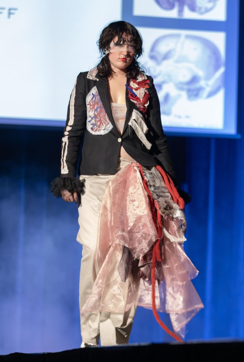 Kent student designer Avery Woodruff walks the runway in her own design during the Modista X Phi Delta Epsilon Fashion Show on Saturday, Oct. 18, 2025.