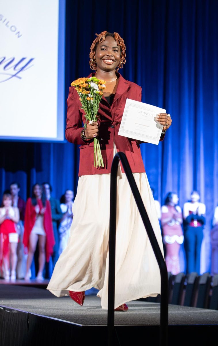Kent student designer Victoria Austin walks down the runway after winning the "Most Creative" award during the Modista X Phi Delta Epsilon Fashion Show on Saturday, Oct. 18, 2025.