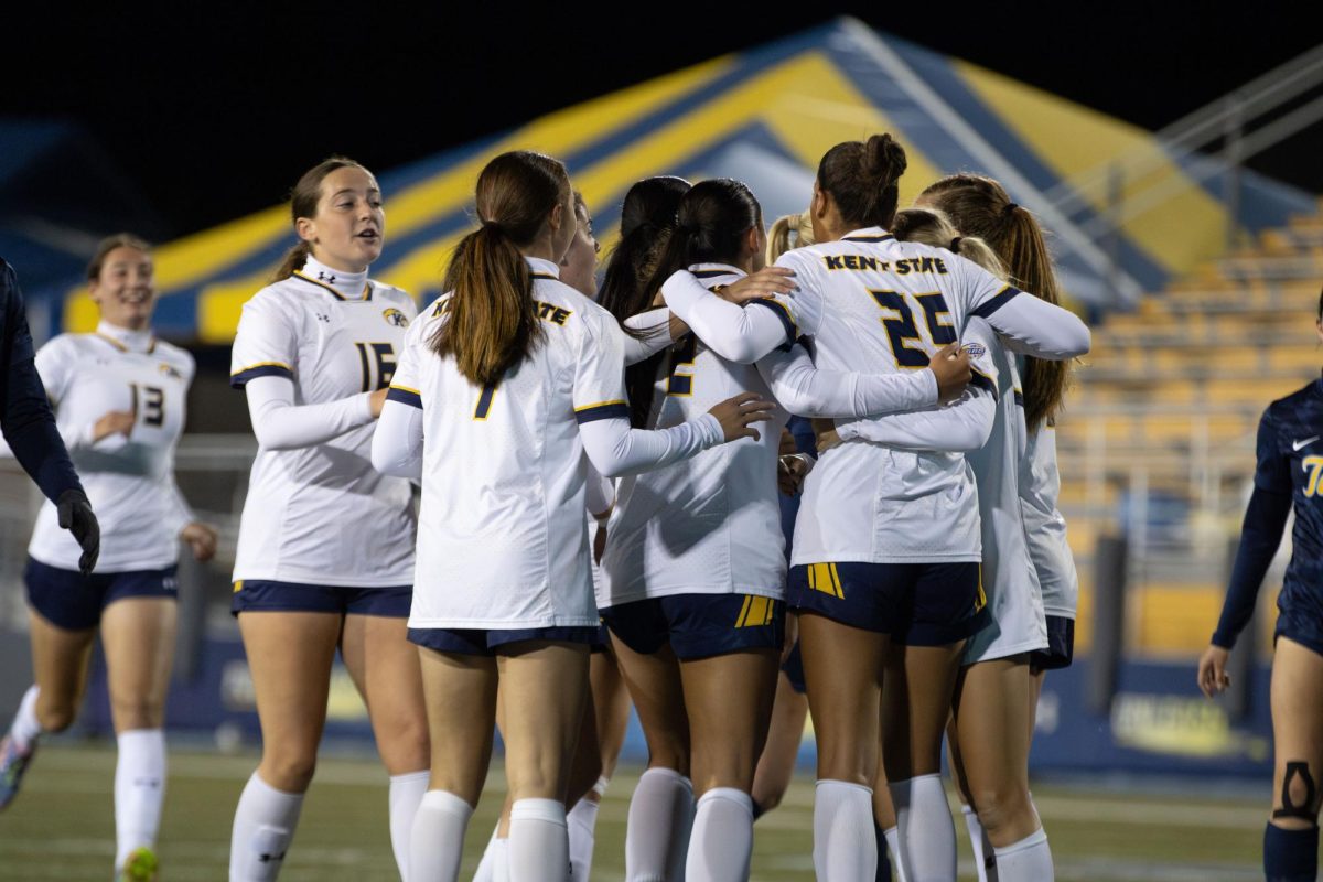 Kent State players huddle together after junior forward, Josie Morgan scores after kicking a penalty kick in the first half of their game against Toledo on Thursday, Oct. 23, 2025.