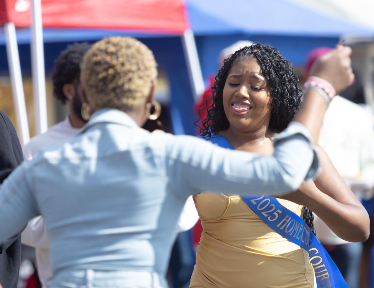Senior Homecoming Court candidate Jovine Gonzalez dances with junior Amaya Rushing while tailgating before the football game vs UMass, Oct. 11, 2025.