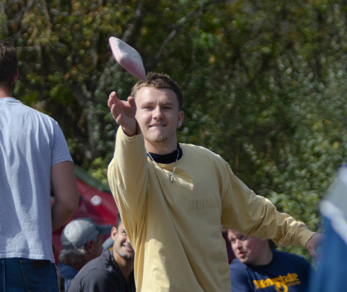 Freshman Ty Blatz plays cornhole while tailgating at the Homecoming football game vs UMass, Oct. 11, 2025.