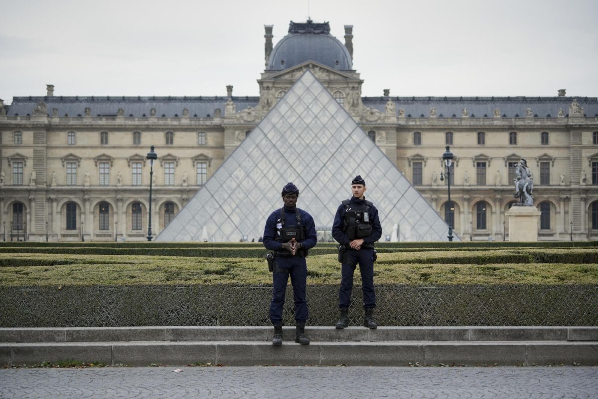 Police stand guard outside the Louvre museum at Louvre on October 19, 2025 in Paris, France.