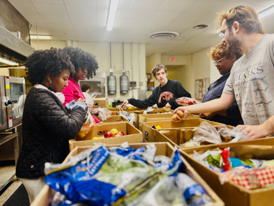 Kent state students sorting food from a late night food recovery in the kitchen on the second floor of the rotunda.