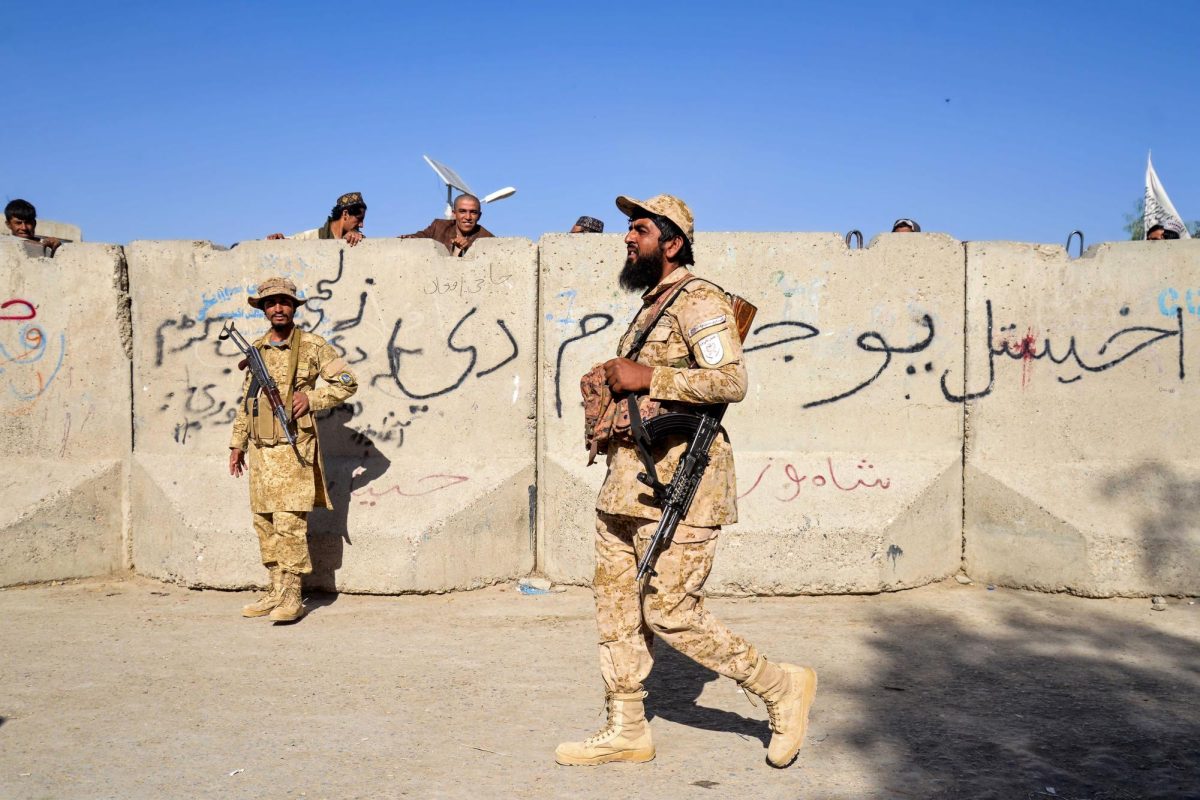 Armed Taliban security personnel keep guard near the closed gate of the zero point border crossing between Afghanistan and Pakistan at Spin Boldak district in Kandahar province on October 12.