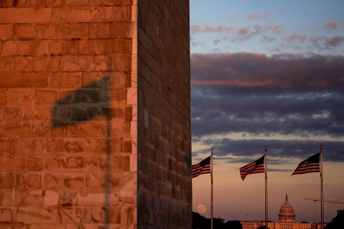 The moon rises above the National Mall in Washington, DC,  in October.