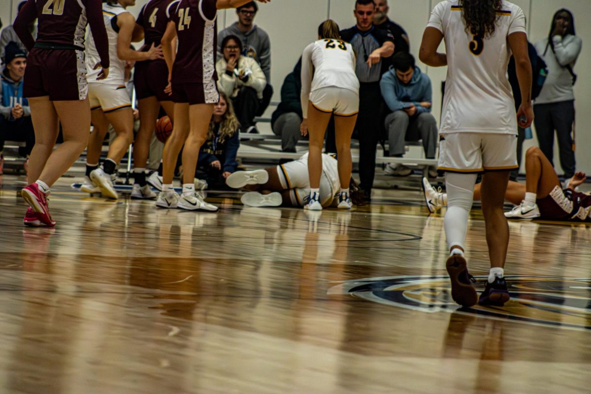 Junior Janae Tyler takes a hit in game against Walsh. Nov. 11, 2025