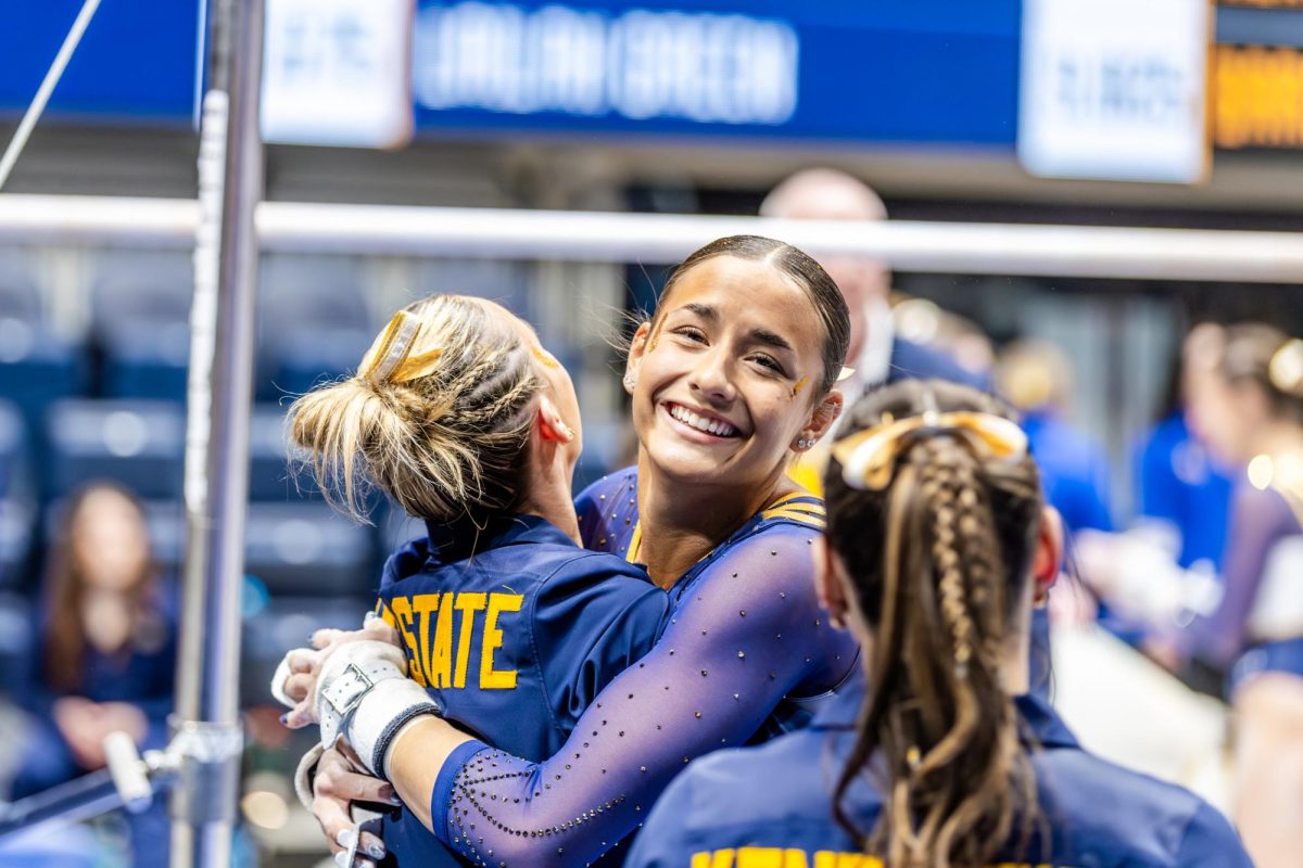 Kent senior Charlie Behner celebrates with her teammates as they compete at the West Virginia meet on Friday Jan. 30, 2026.