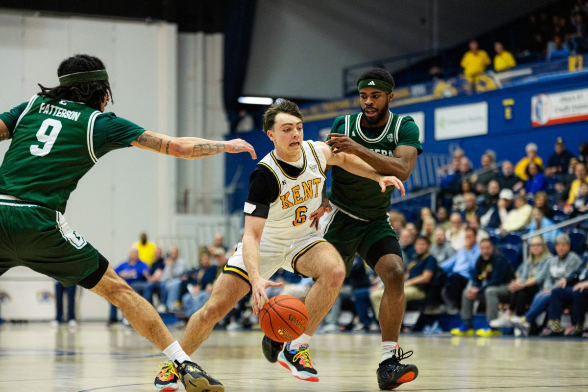 Kent freshman Quinn Woidke dribbles past opponents during their game against Eastern Michigan University on Feb. 11, 2026. 