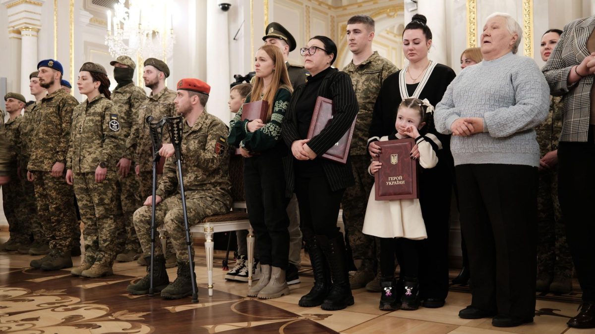 The family of Capt. Ivan Kotsur, his wife Olesya and daughter Veronika receive a posthumous award at the ceremony attended by Zelensky.