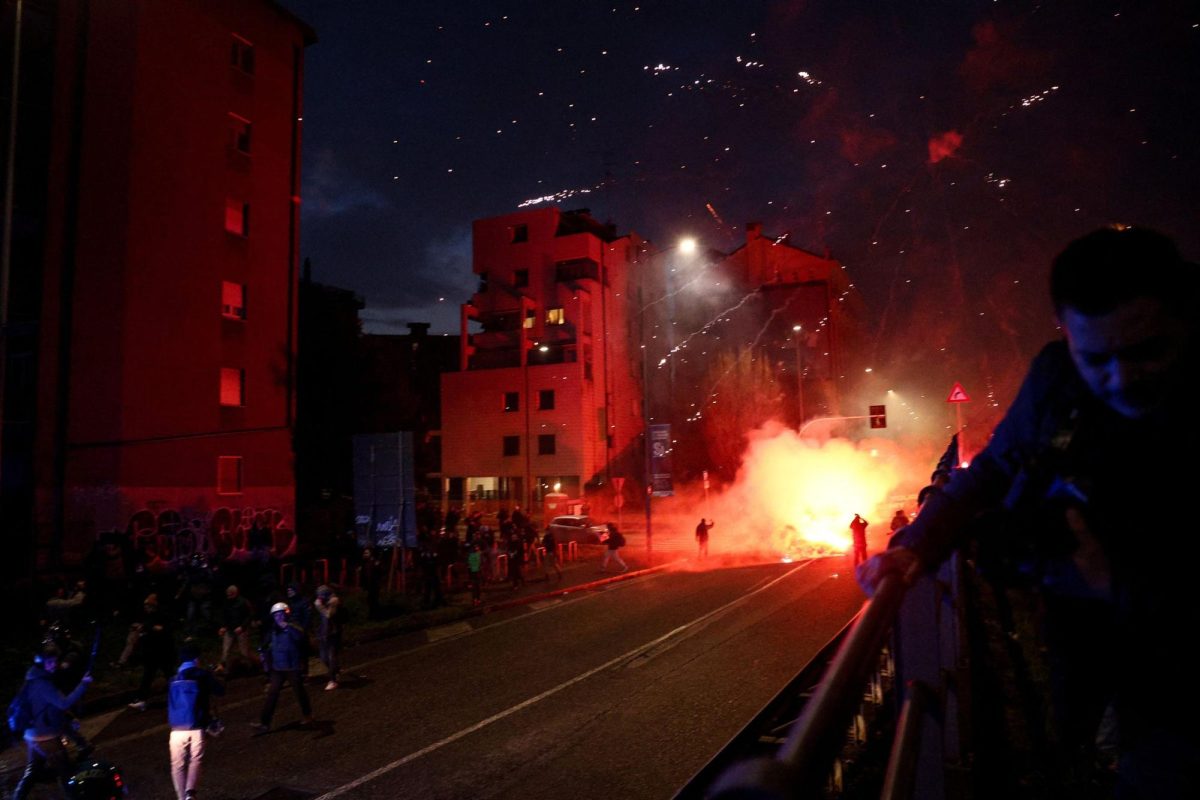 Fireworks explode as demonstrators use them against police officers while trying to block a road leading to the Santa Giulia Arena, on the day of a protest against the environmental, economic and social impact of the Milano-Cortina 2026 Winter Olympics, in Milan, Italy, on Saturday.