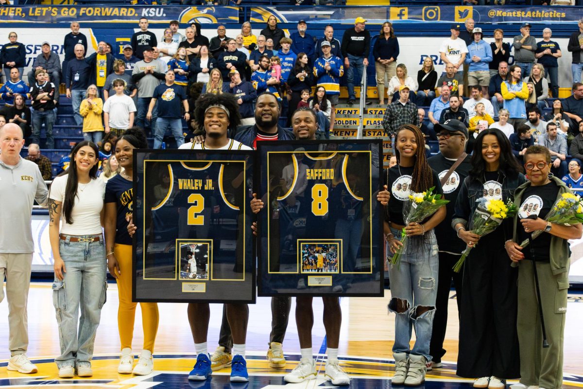 Kent graduate students Rob Whaley Jr and Morgan Safford hold up their jersey frames before the start of their game against Western Michigan on March 6, 2026.