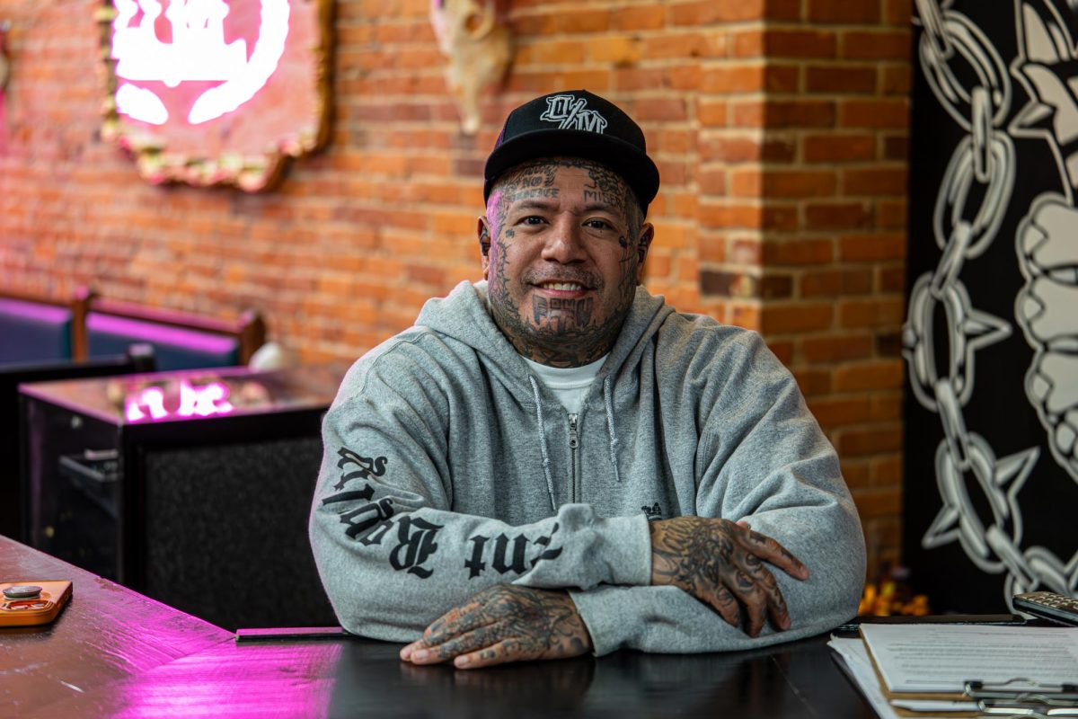 Defiance Tattoos owner Rob Bohn poses for a photo at the front desk of the shop on March 20, 2026.